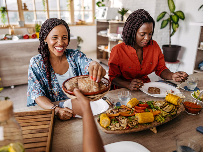 people happily dining on vegetarian food