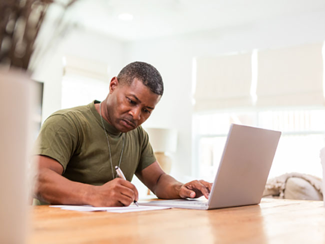 Veteran filling out paperwork at desk