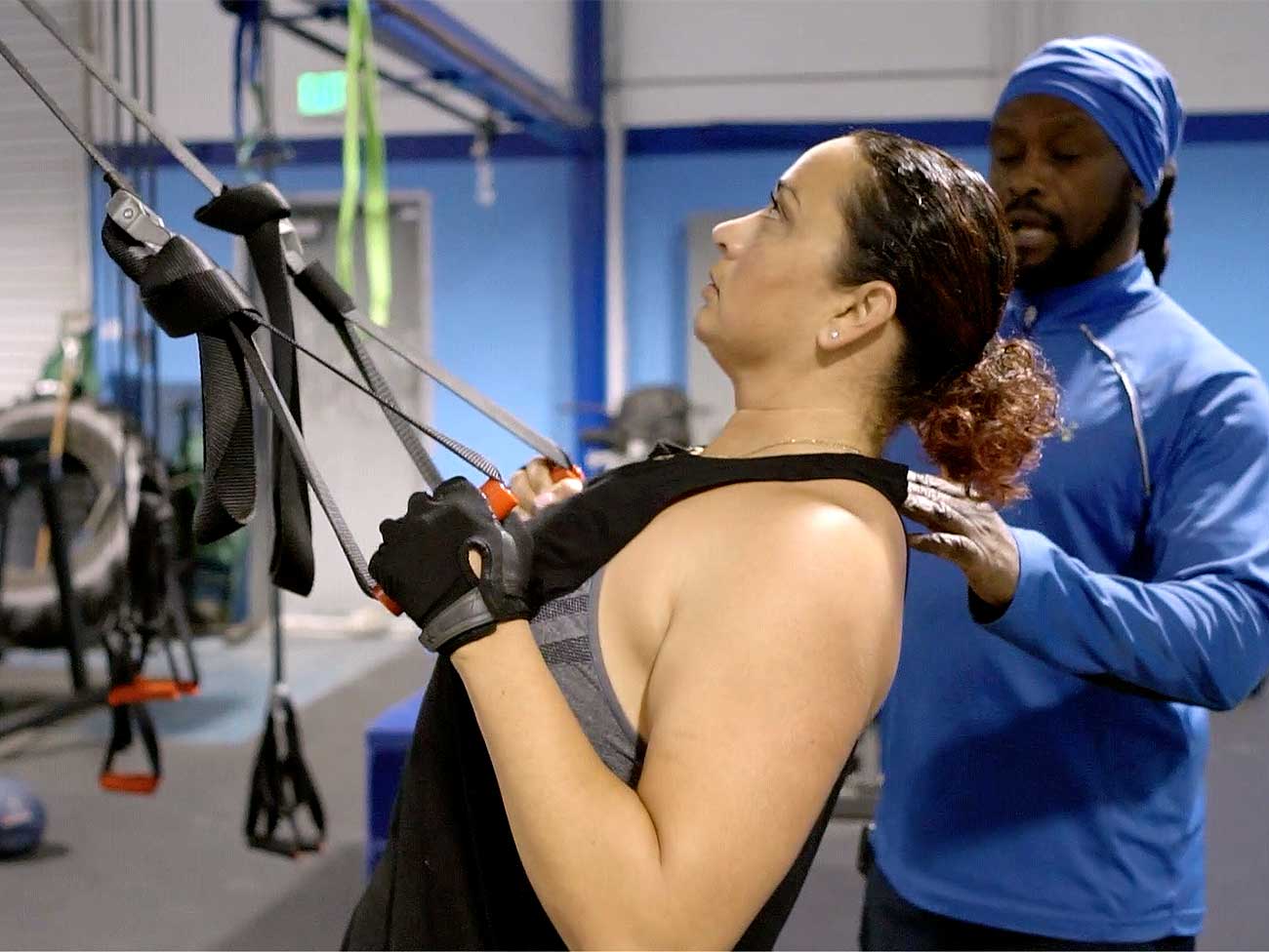 Kaiser Permanente member Michelle Wofford working out at the gym with a personal trainer.