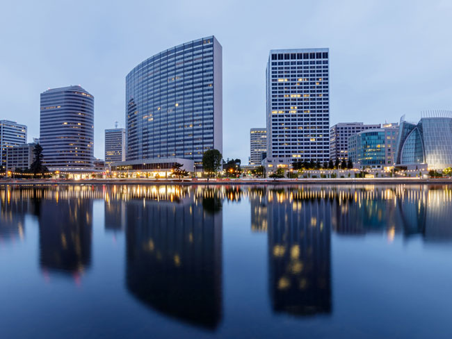 evening view of office buildings by a lake