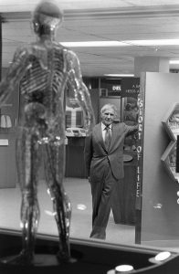 Dr. Sidney Garfield with a transparent man model in Health Education Center.