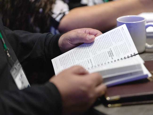 A bargaining representative thumbs through the last Alliance national contract booklet.