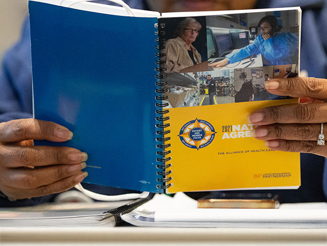 Unidentifiable person reading the Alliance National Agreement