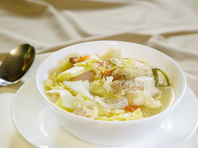 A hearty bowl of chicken soup filled with healthy vegetables. 