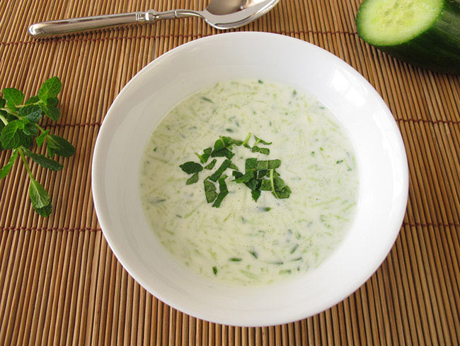 Cacik , or chilled yogurt cucumber soup, in a white bowl.