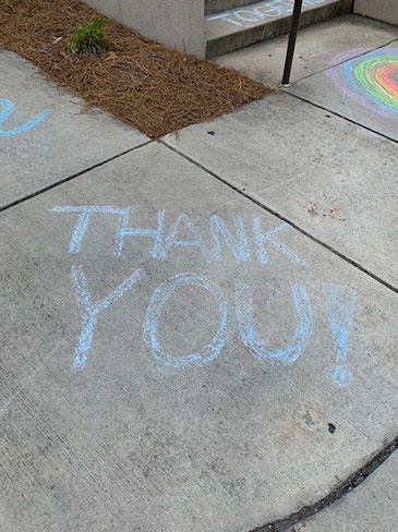 Thank you written in chalk on a sidewalk 