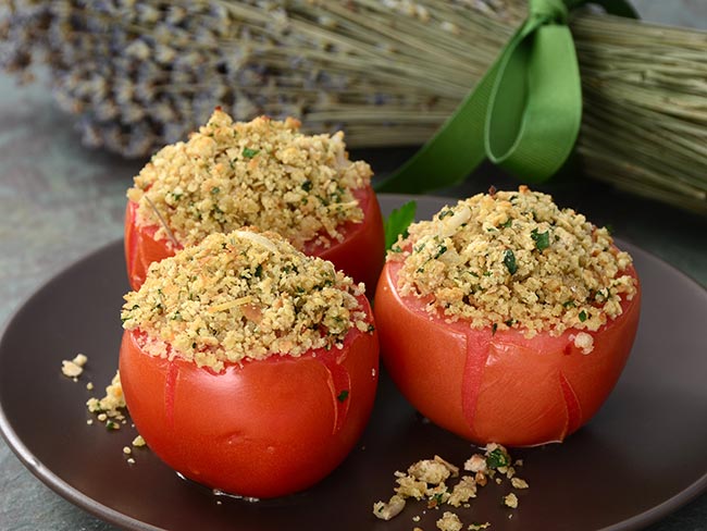 3 herb-stuffed tomatoes on a plate