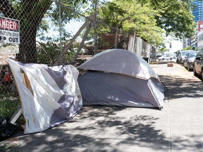 Homeless encampment on sidewalk.