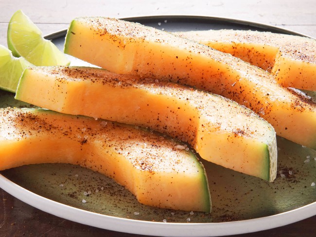 Cantaloupe slices dusted with chile powder.