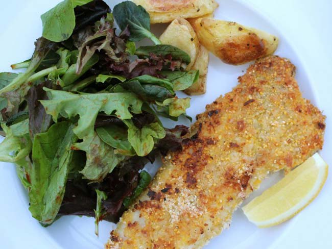 Oven baked fish and chips served with a salad 