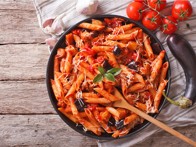 Roasted vegetables and heirloom tomato pasta served in a skillet