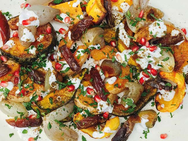 Chunks of roasted squash and shallots mixed with pomegranate seeds and drizzled with Greek yogurt sauce.