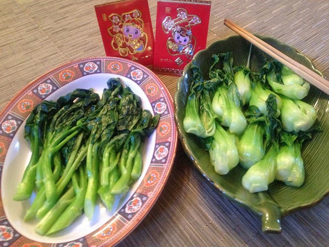 Stir-fry chinese Bok choy served in ceramic bowls with red letter gift