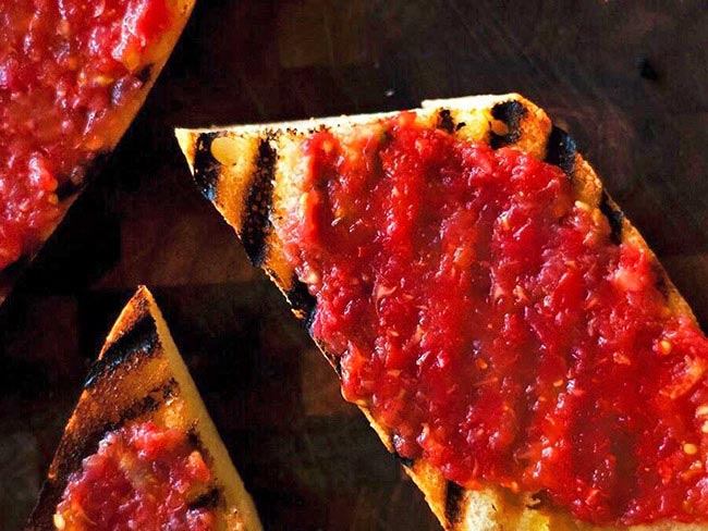 Toast with smeared tomato on it.